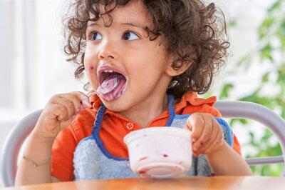 Young child eating yogurt