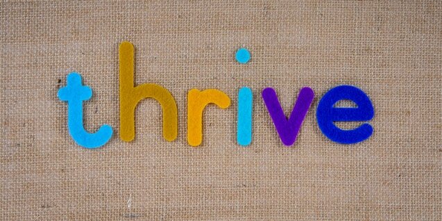 An image that says the word thrive